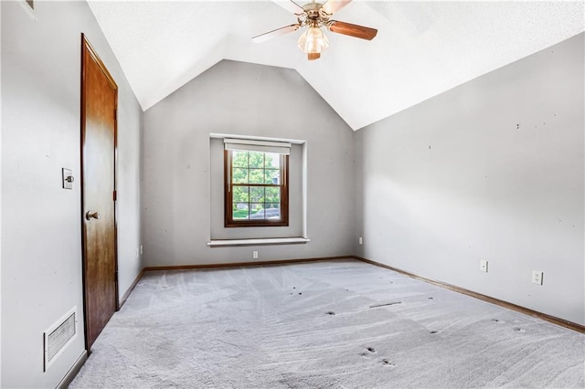 6503 NW Sioux Ct, Parkville, MO 64152 - spare room featuring light carpet, a ceiling fan, lofted ceiling, and baseboards
