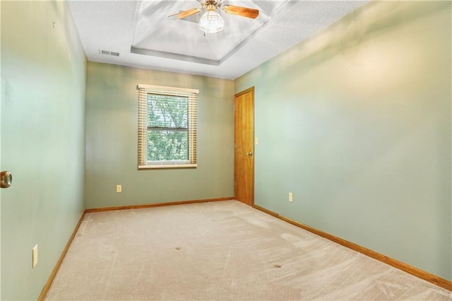 6503 NW Sioux Ct, Parkville, MO 64152 - unfurnished room with baseboards, light carpet, ceiling fan, and a raised ceiling