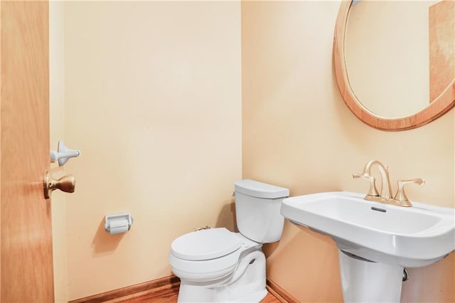 6503 NW Sioux Ct, Parkville, MO 64152 - half bathroom with toilet, baseboards, and wood finished floors