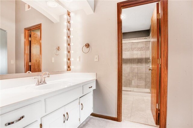 6503 NW Sioux Ct, Parkville, MO 64152 - bathroom featuring a shower stall, vanity, tile patterned flooring, and baseboards
