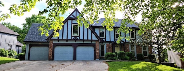 5806 N Kensington Ave, Kansas City, MO 64119 - english style home featuring concrete driveway, brick siding, an attached garage, and a front yard
