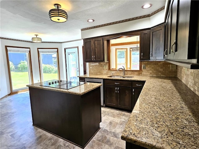 5806 N Kensington Ave, Kansas City, MO 64119 - kitchen featuring a sink, black electric stovetop, a center island, decorative backsplash, and dark brown cabinetry