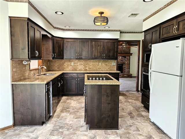 5806 N Kensington Ave, Kansas City, MO 64119 - kitchen featuring freestanding refrigerator, a sink, a kitchen island, black electric stovetop, and dark brown cabinetry