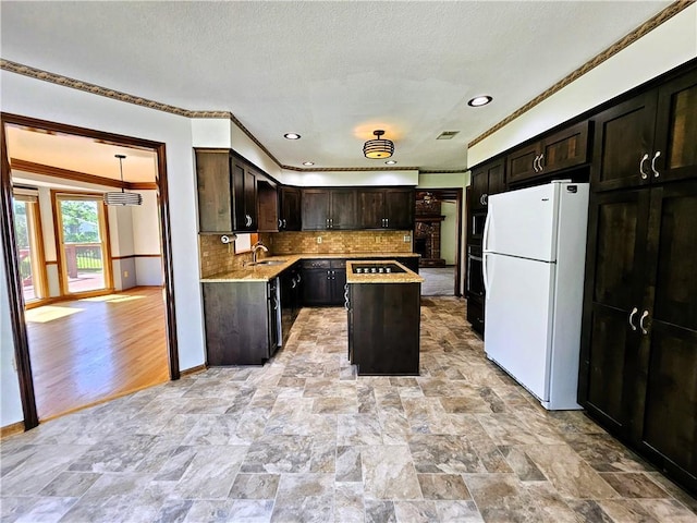 5806 N Kensington Ave, Kansas City, MO 64119 - kitchen with freestanding refrigerator, a sink, ornamental molding, black electric cooktop, and tasteful backsplash