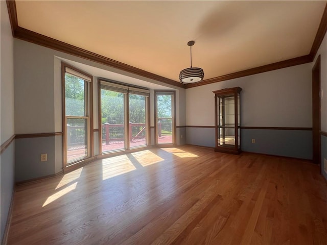 5806 N Kensington Ave, Kansas City, MO 64119 - empty room with crown molding, wood finished floors, and baseboards