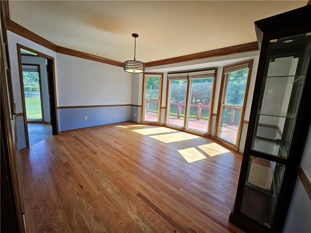 5806 N Kensington Ave, Kansas City, MO 64119 - unfurnished dining area with ornamental molding, wood finished floors, and baseboards