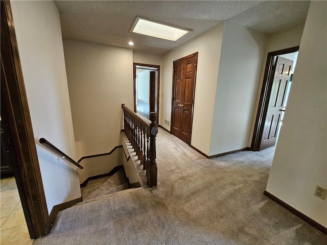 5806 N Kensington Ave, Kansas City, MO 64119 - staircase with baseboards, carpet, a textured ceiling, and recessed lighting