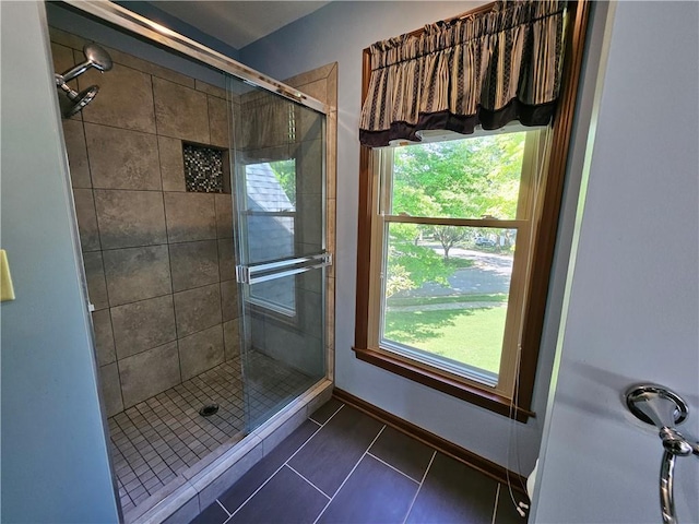 5806 N Kensington Ave, Kansas City, MO 64119 - full bath featuring a stall shower, healthy amount of natural light, tile patterned flooring, and baseboards