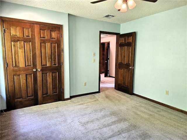 5806 N Kensington Ave, Kansas City, MO 64119 - unfurnished bedroom featuring light colored carpet, baseboards, a textured ceiling, and ceiling fan