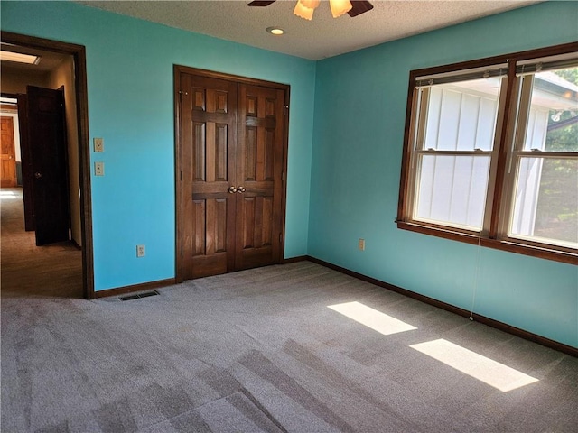5806 N Kensington Ave, Kansas City, MO 64119 - unfurnished bedroom featuring carpet floors, baseboards, a closet, a ceiling fan, and a textured ceiling
