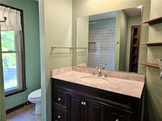5806 N Kensington Ave, Kansas City, MO 64119 - bathroom with toilet, vanity, tile patterned floors, and baseboards