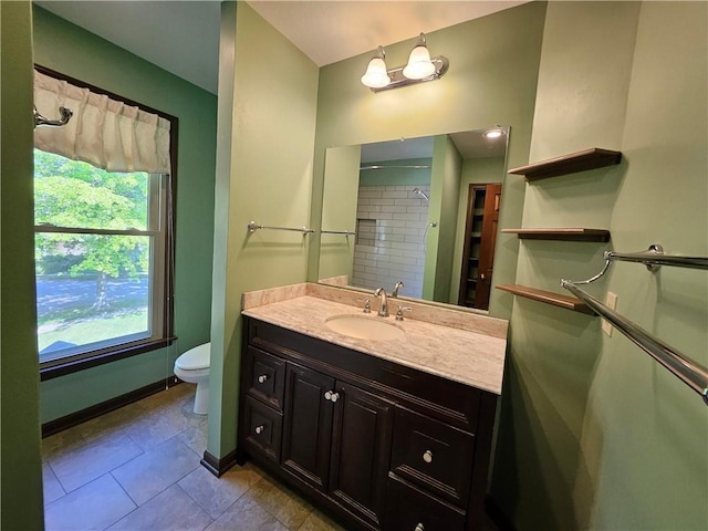5806 N Kensington Ave, Kansas City, MO 64119 - full bathroom featuring toilet, tile patterned floors, vanity, and baseboards
