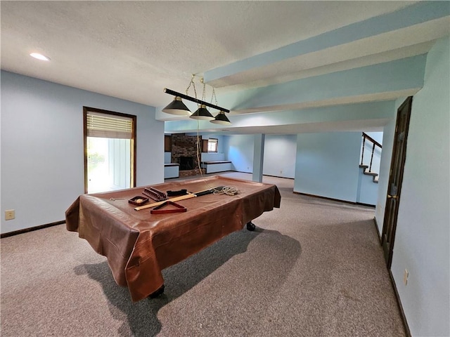 5806 N Kensington Ave, Kansas City, MO 64119 - playroom featuring carpet floors, baseboards, a large fireplace, billiards table, and a textured ceiling