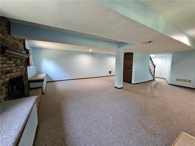 5806 N Kensington Ave, Kansas City, MO 64119 - finished basement with baseboards, stairs, a fireplace, carpet, and a textured ceiling