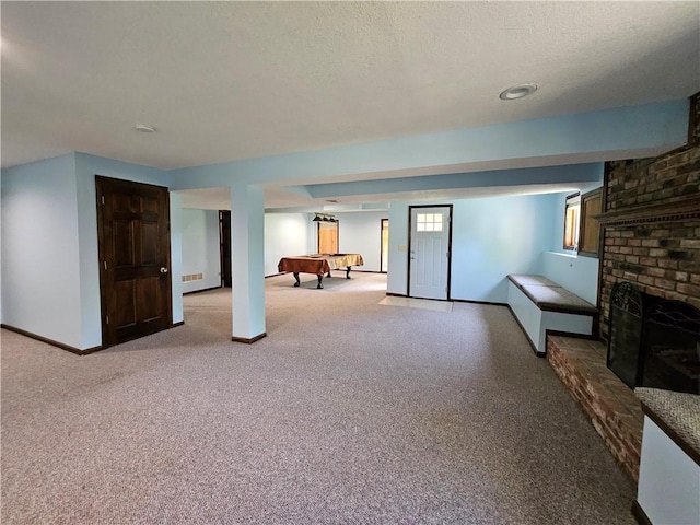 5806 N Kensington Ave, Kansas City, MO 64119 - unfurnished living room featuring pool table, carpet floors, baseboards, and a textured ceiling