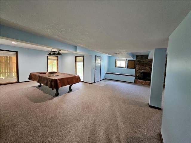 5806 N Kensington Ave, Kansas City, MO 64119 - recreation room featuring carpet floors, a brick fireplace, baseboards, billiards table, and a baseboard radiator