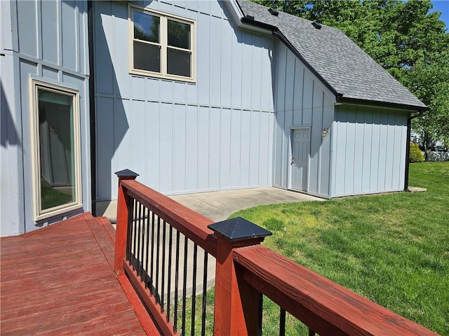 5806 N Kensington Ave, Kansas City, MO 64119 - view of side of home featuring a shingled roof, a deck, a lawn, and board and batten siding