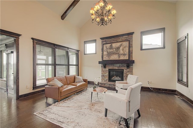 1110 Metfield Ln, Raymore, MO 64083 - living area with baseboards, high vaulted ceiling, a stone fireplace, a chandelier, and dark wood finished floors