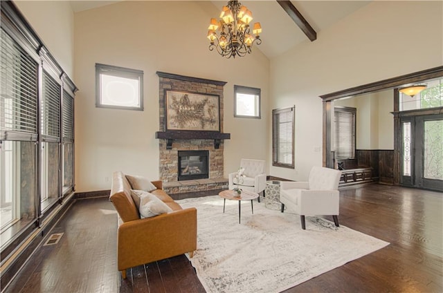 1110 Metfield Ln, Raymore, MO 64083 - living room with high vaulted ceiling, a fireplace, a chandelier, wood finished floors, and plenty of natural light