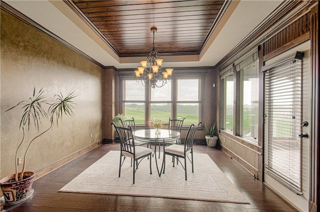 1110 Metfield Ln, Raymore, MO 64083 - dining room featuring a raised ceiling, a chandelier, ornamental molding, baseboards, and dark wood finished floors