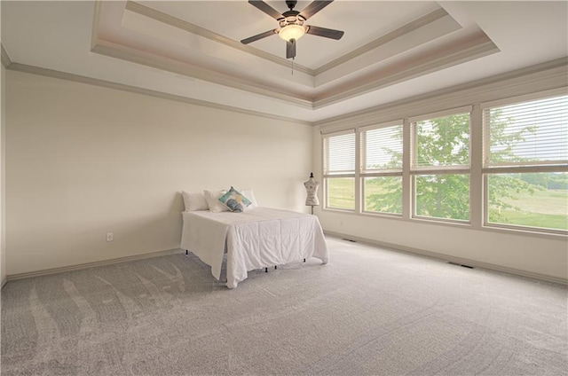 1110 Metfield Ln, Raymore, MO 64083 - bedroom with a tray ceiling, ornamental molding, carpet floors, a ceiling fan, and baseboards