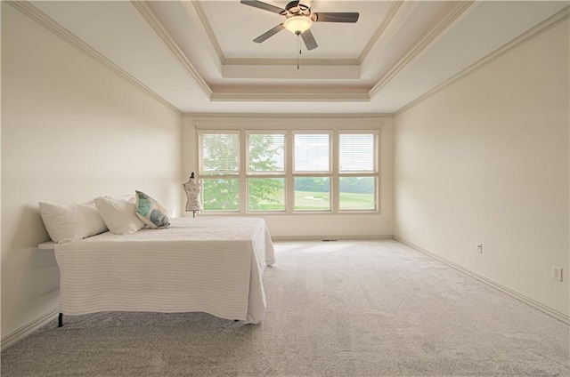 1110 Metfield Ln, Raymore, MO 64083 - carpeted bedroom featuring multiple windows, a tray ceiling, ornamental molding, ceiling fan, and baseboards