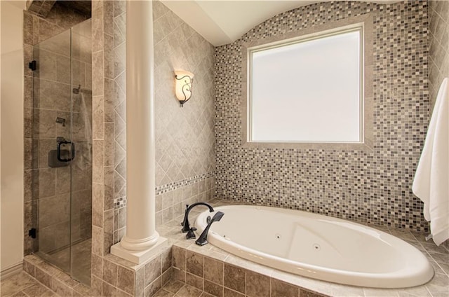 1110 Metfield Ln, Raymore, MO 64083 - bathroom with a jetted tub, a shower stall, and tile walls