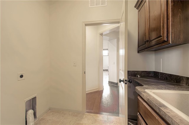 1110 Metfield Ln, Raymore, MO 64083 - laundry room featuring cabinet space, hookup for an electric dryer, and baseboards