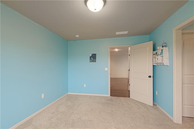 1110 Metfield Ln, Raymore, MO 64083 - unfurnished bedroom with carpet flooring, baseboards, and a textured ceiling