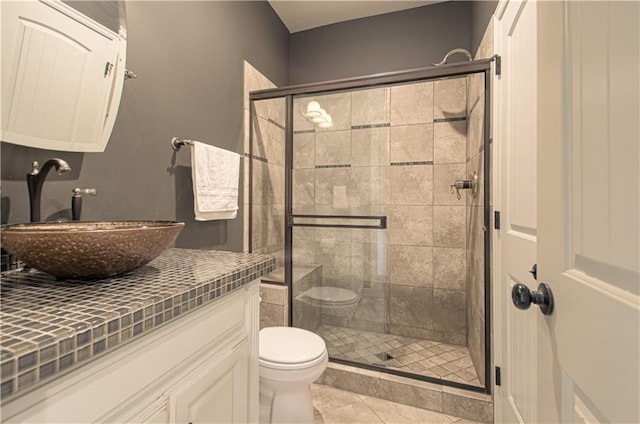 1110 Metfield Ln, Raymore, MO 64083 - full bathroom with toilet, vanity, a shower stall, and tile patterned floors