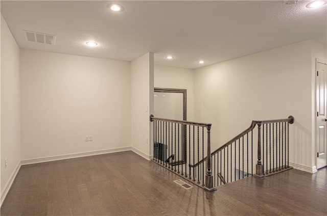 1110 Metfield Ln, Raymore, MO 64083 - unfurnished room with wood finished floors, baseboards, recessed lighting, and a textured ceiling