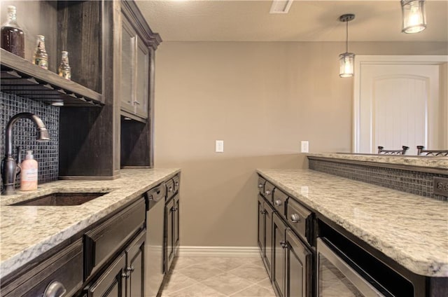 1110 Metfield Ln, Raymore, MO 64083 - kitchen with a sink, beverage cooler, baseboards, hanging light fixtures, and stainless steel dishwasher