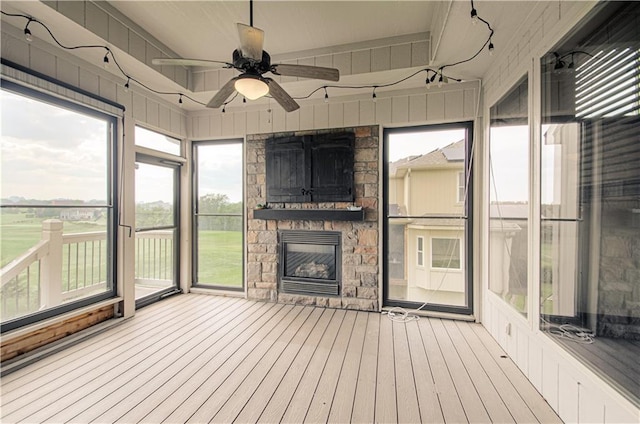 1110 Metfield Ln, Raymore, MO 64083 - unfurnished sunroom featuring ceiling fan and a stone fireplace