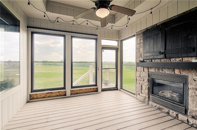 1110 Metfield Ln, Raymore, MO 64083 - unfurnished sunroom featuring ceiling fan and a stone fireplace