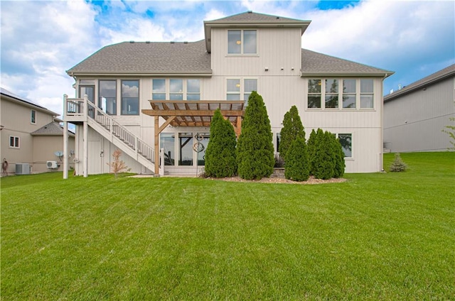 1110 Metfield Ln, Raymore, MO 64083 - rear view of house with a yard, roof with shingles, central air condition unit, and stairway