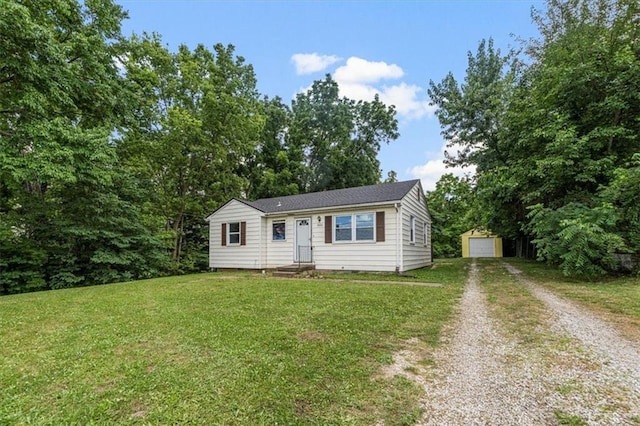 9021 E 79th St, Raytown, MO 64138 - view of front of home featuring driveway, an outdoor structure, a front lawn, and a garage