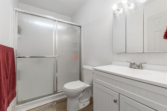 9021 E 79th St, Raytown, MO 64138 - full bath with vanity, wood finished floors, and a stall shower