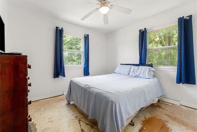 9021 E 79th St, Raytown, MO 64138 - bedroom with baseboard heating, a ceiling fan, and wood finished floors