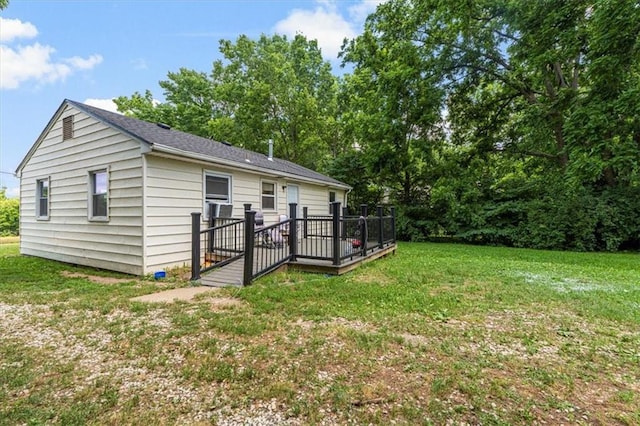 9021 E 79th St, Raytown, MO 64138 - back of property featuring a wooden deck and a lawn