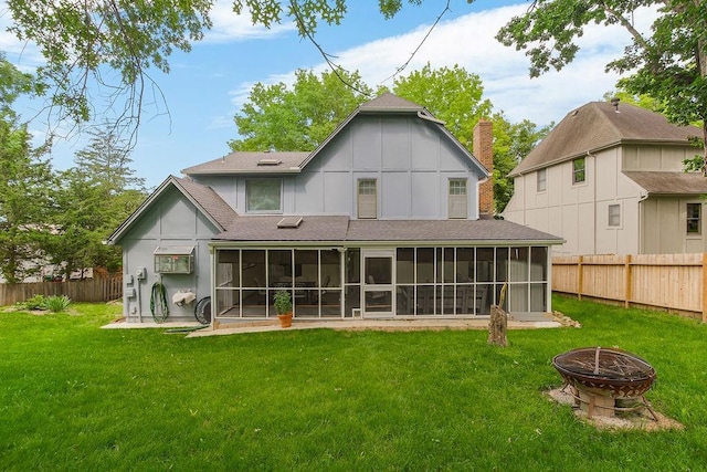 11506 Knox St, Overland Park, KS 66210 - back of property featuring an outdoor fire pit, a sunroom, roof with shingles, and a fenced backyard