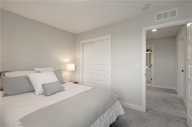 bedroom with baseboards, carpet flooring, and a closet