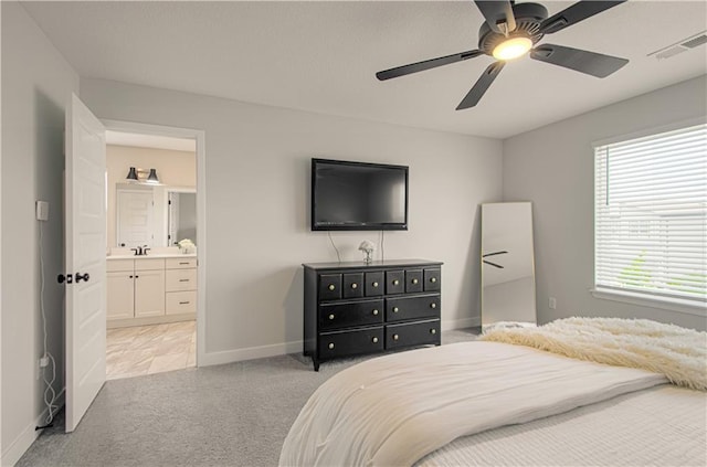 18061 W Hauser St, Overland Park, KS 66013 - bedroom with light colored carpet, baseboards, ensuite bath, a ceiling fan, and a sink