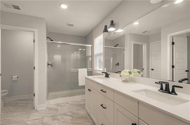 18061 W Hauser St, Overland Park, KS 66013 - full bathroom featuring a shower stall, baseboards, toilet, marble finish floors, and double vanity
