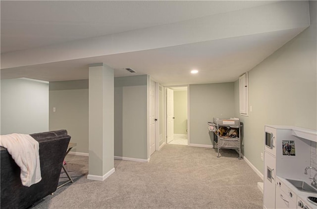 18061 W Hauser St, Overland Park, KS 66013 - finished basement with light carpet, baseboards, and a sink