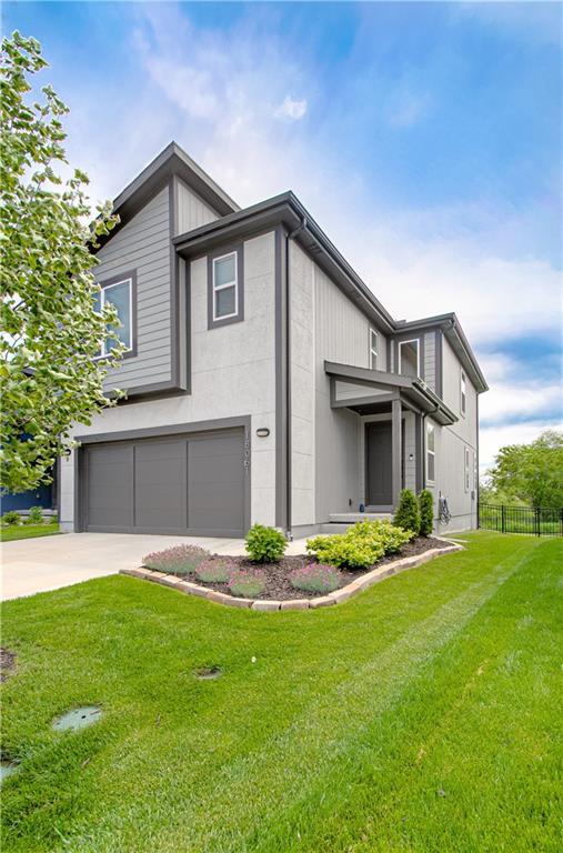 18061 W Hauser St, Overland Park, KS 66013 - view of side of home with a garage and concrete driveway