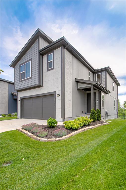 18061 W Hauser St, Overland Park, KS 66013 - view of front of property with a garage and concrete driveway