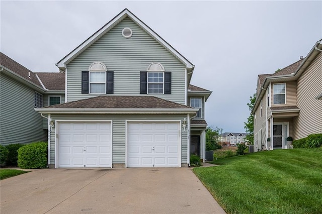 8008 NE Elmwood Ave, Kansas City, MO 64119 - traditional home featuring driveway, a front yard, a garage, and central air condition unit