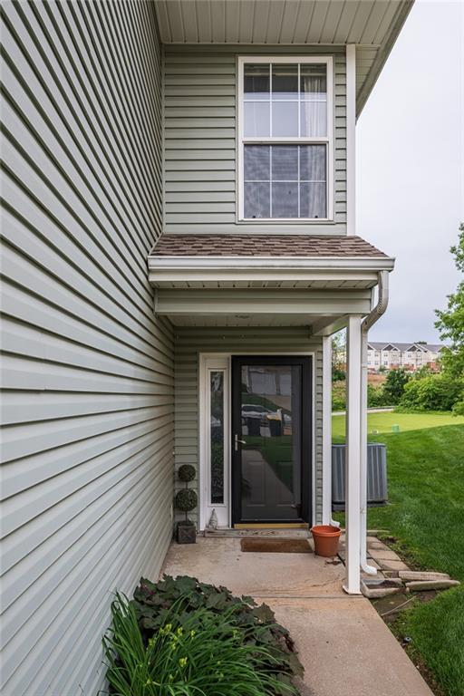 8008 NE Elmwood Ave, Kansas City, MO 64119 - doorway to property featuring a yard and central AC unit