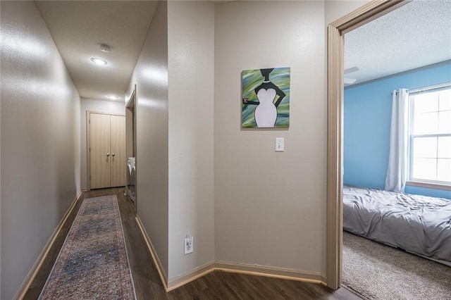 8008 NE Elmwood Ave, Kansas City, MO 64119 - hallway featuring dark wood-type flooring, baseboards, and a textured ceiling