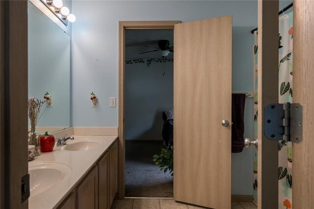 8008 NE Elmwood Ave, Kansas City, MO 64119 - full bathroom featuring double vanity, tile patterned floors, and ceiling fan